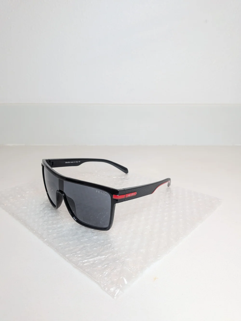 Prada Men’s Black Shield Sunglasses Red Logo Sport